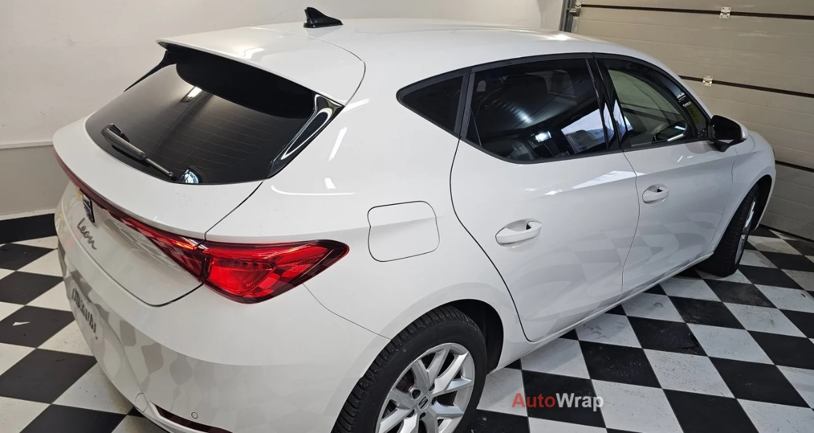 Biały Seat Leon z przyciemnionymi szybami
